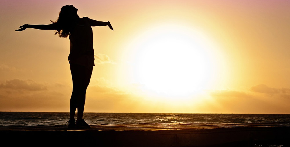 Happy woman, silhouette and sunset